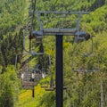 Square Chairlifts over abundant green trees and hiking trails during off season months