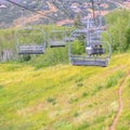 Square Chairlifts over mountain with grasses and trails in Park City Utah in summer