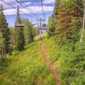 Square Chairlifts over mountain with grasses and trees during off season in Park City