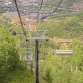 Square Chairlifts overlooking trails and buildings at a ski resort during off season