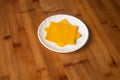 Square Cheese Slice yellow served in plate isolated on wooden table top view of indian food Royalty Free Stock Photo