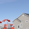 Square Childrens playground at a park in South Jordan City against exterior of house