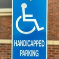 Square Close up of Handicapped Parking sign against blurred red brick wall of church Royalty Free Stock Photo