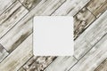 Square coaster on wooden table Royalty Free Stock Photo