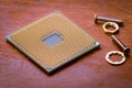 A square computer processor pulled from a broken computer. The processor is on the table. Royalty Free Stock Photo