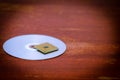 A square computer processor pulled from a broken computer. The processor is on the table. View of the contacts through a magnifyin Royalty Free Stock Photo