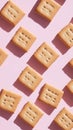 Square cookies arranged in a pattern on a pink background. Food flat lay concept Royalty Free Stock Photo