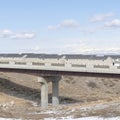 Square crop Concrete bridge and houses on snowy neighborhood in South Jordan City in winter