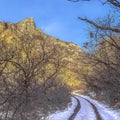 Square crop Dirt road trail with tire track and snow in winter in Provo Canyon mountain