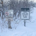 Square crop Foot path and signages at the snow covered slope of Wasatch Mountains in winter