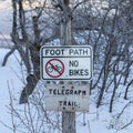 Square crop Signages by a foot path trail at Wasatch Mountains blanketed with snow in winter