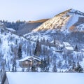 Square crop Snowed in mountain in Park City during winter with homes under overcast sky