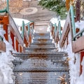 Square crop Stairway going down to a road on a hill with fresh white snow in winter Royalty Free Stock Photo