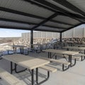 Square crop Tables with seats inside a gabled roof pavilion in South Jordan City in Utah