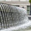 Square crop Water fountain trickling on a circular pool outside Utah State Capital Building