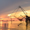 Square dip net catch fish during sunrise