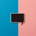 Square empty chalkboard wooden speech bubble on pink and blue Royalty Free Stock Photo