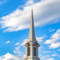 Square Exterior of a beautiful church with a white steeple against cloudy blue sky Royalty Free Stock Photo