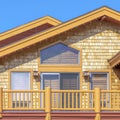 Square Exterior of home in Park City Utah with sunlit colorful wall against blue sky