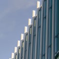 Square Exterior of a modern building with vertical sunshades outside the glass windows Royalty Free Stock Photo