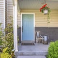 Square Exterior view of a home with stepas and porch in front of the pastel blue door