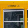 Square Exterior of a yellow school bus with a close up view of its glass window
