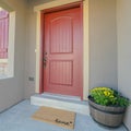 Square Facade of home with red front door and wooden shutters on the sliding window