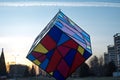 A figure in the city center resembles a multi-colored cube shot at sunset in a winter evening