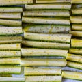 Square flat lay background of sliced zucchini