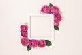 Square flower frame made of pink rose on a beige background. Royalty Free Stock Photo