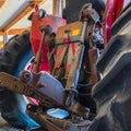 Square frame Back view of an old vintage tractor with black wheels and red paint at a barn Royalty Free Stock Photo