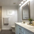 Square frame Bathroom interior with a bathtub in front of thee vanity area and mirror Royalty Free Stock Photo