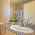 Square frame Bathroom interior with close up of sink cabinet and mirror beside the toilet Royalty Free Stock Photo