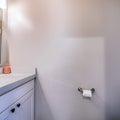 Square frame Bathroom interior with view of sink cabinets wall mirror lights and toilet Royalty Free Stock Photo