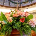 Square frame Beautiful potted colorful flowers with leaves under stained glass dome roof