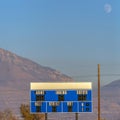 Square frame Blue and white electronic baseball scoreboard at a sports field