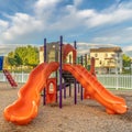 Square frame Bright orange and blue slides at a colorful fun playground for children
