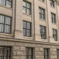 Square frame Building facade with decorative mouldings on the white stone exterior wall Royalty Free Stock Photo