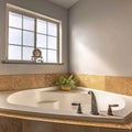 Square frame Built in bathtub at the corner of a bathroom with frosted glass window