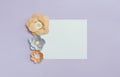 Square frame card with grey brown color paper flowers on pastel violet blue background. Flat lay, copy space, floral design Royalty Free Stock Photo