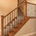 Square frame Carpeted stairs with wood handrail and metal railing inside an empty new home