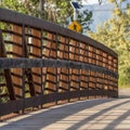 Square frame Close up of a bridge with metal guardrail and wood deck on a sunny day