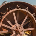 Square frame Close up of the damaged wheels of an old vintage tractor against sunny blue sky Royalty Free Stock Photo