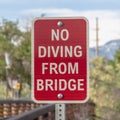 Square frame Close up of a No Diving sign beside a bridge with brown metal guardrail Royalty Free Stock Photo