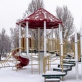 Square frame Colorful playground for children at a park covered with snow at winter season Royalty Free Stock Photo