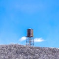 Square frame Cylindrical water storage tank container on a steel tower at Wasatch Mountains Royalty Free Stock Photo