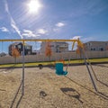 Square frame Deserted A-frame kids swings on a playground Royalty Free Stock Photo