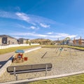 Square frame Empty bench overlooking a small kids playground Royalty Free Stock Photo