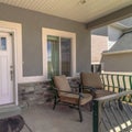 Square frame Entrance of home with chairs at the porch and front door with glass panes Royalty Free Stock Photo