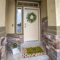 Square frame Entrance of a home with white wooden front door sidelight and transom window